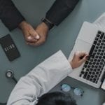 two people in front of computer