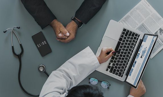 two people in front of computer