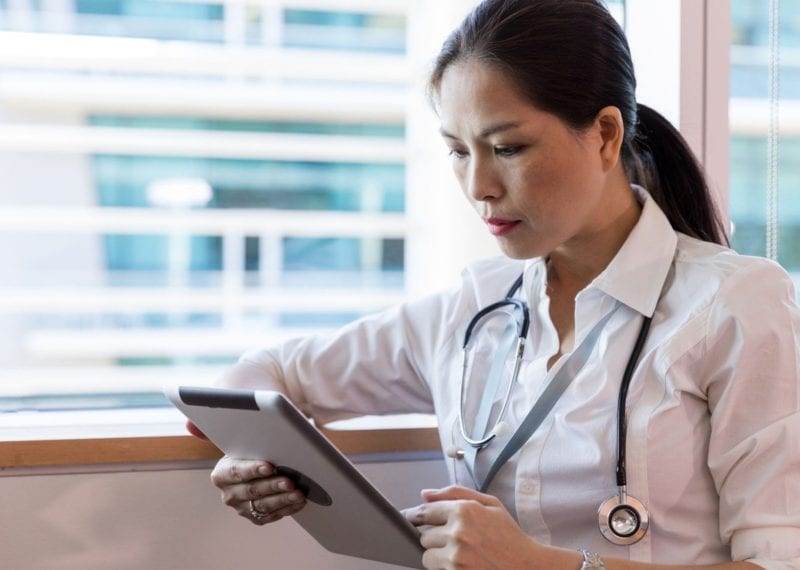 doctor reviewing data on a tablet