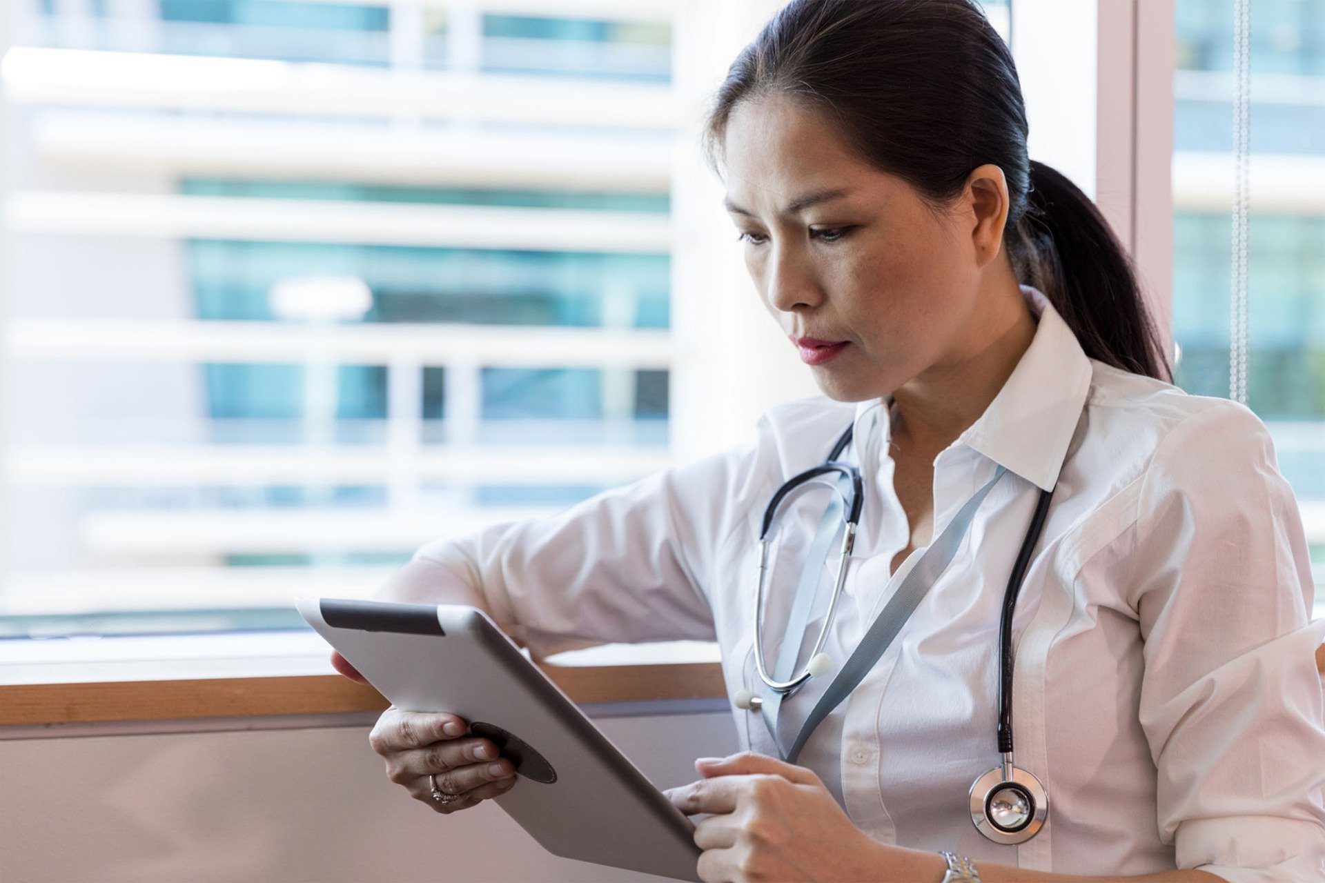 doctor reviewing data on a tablet